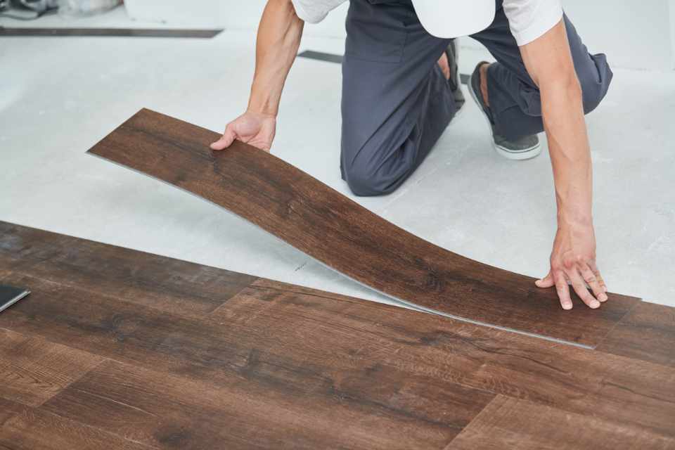 installing dark wood look luxury vinyl planks in new home